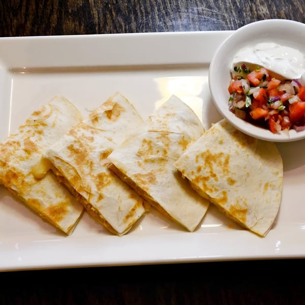 Los Amigos Don Juan quesadillas with melted cheese, served with pico de gallo and sour cream.